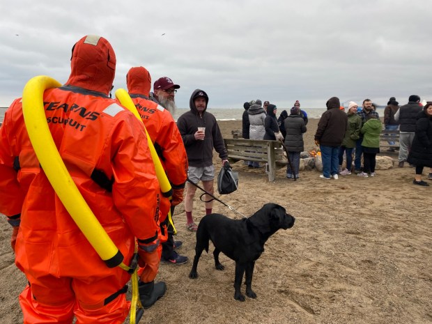 Members of the Fairport Harbor Fire Department walk towards the water in preparation of the Port Plunge (Frank Mecham- The News-Herald.)