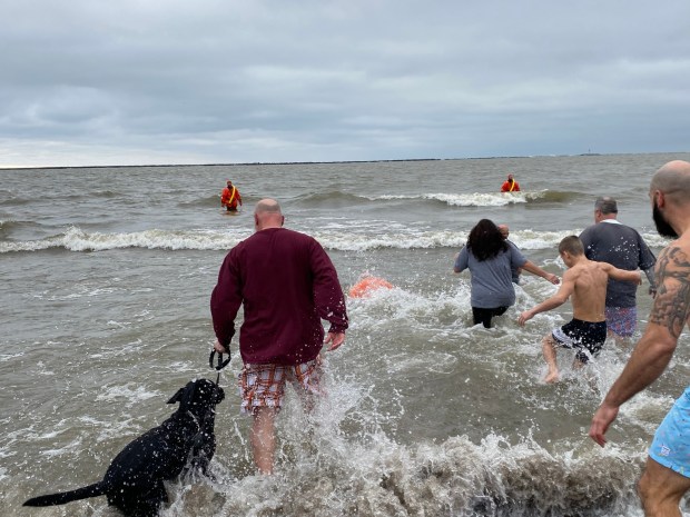 Plungers jump into the water during Fairport Harbor Arts and Culture Alliance Port Plunge. (Frank Mecham- The News-Herald.)